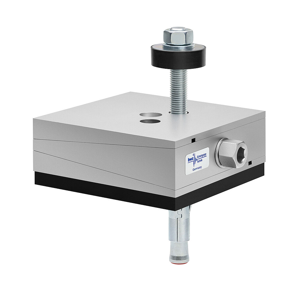 a square, height-adjustable machine mount made of precision-milled metal, adjusted in middle position, consisting of top, middle and bottom part lacquered in silver colour, with the wedge-shaped middle part featuring a protruding centered hexagonal screw for height adjustment, two holes for fastening screws in the top part, a fastening screw passing through the bottom part and sticking out on top with a screwhead isolation disc at the top screw end, a medium-thick black elastomer with smooth surface for vibration damping at the bottom and below, a zinc-galvanized ground dovel, isolated on white background