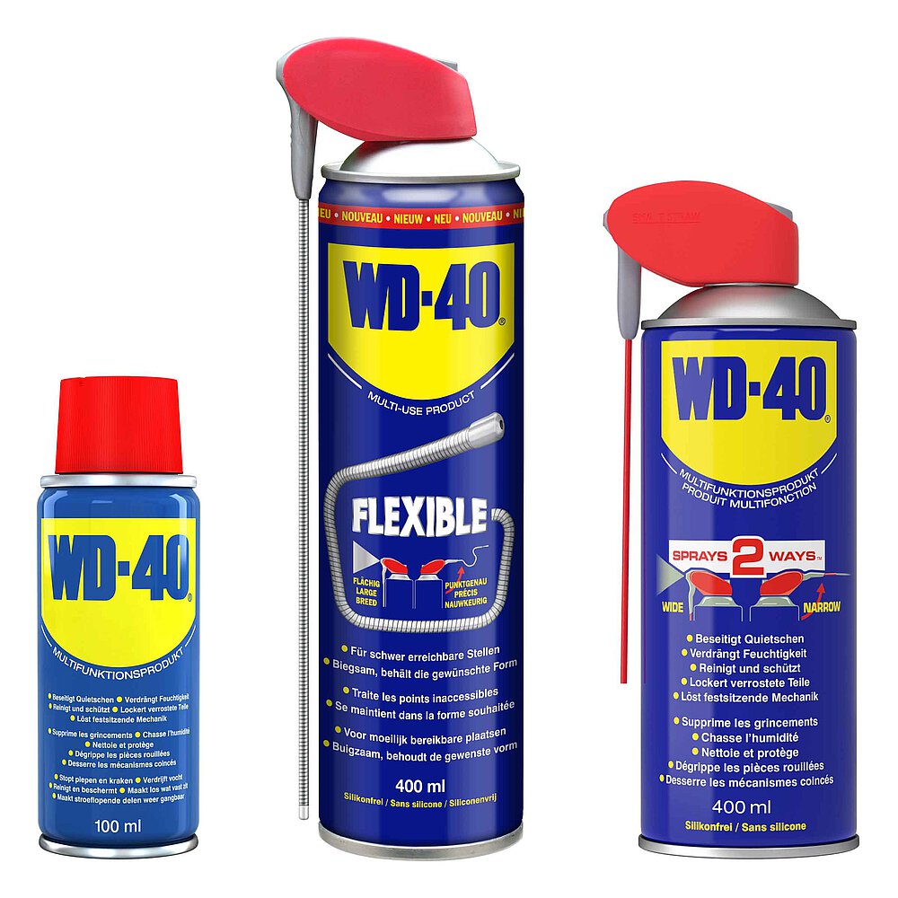 a group picture of three blue-yellow WD-40® spray cans of various size with red nozzle head on top and hinged spray straw at the side or red sealing cap, isolated on white background