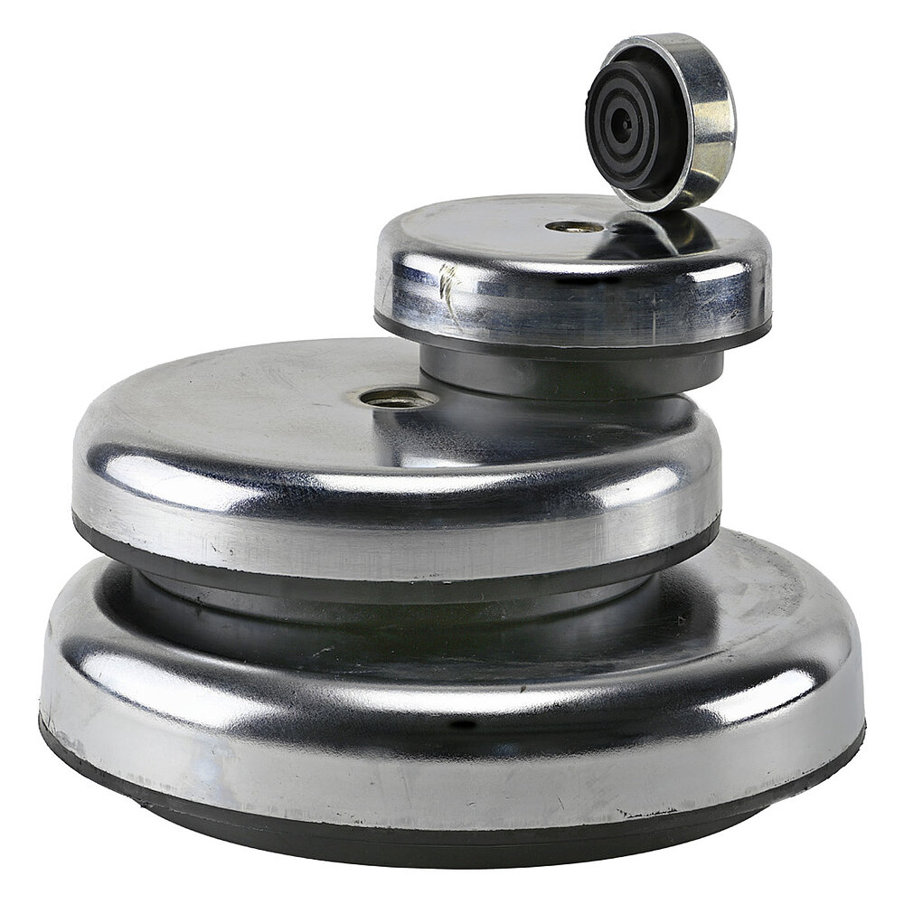 a square group picture of four round vibration dampers of different diameters, stacked onto each other, with matte shining zinc-galvanized metal surface, black vulcanized elastomer at the bottom and central inner thread for levelling screws, isolated on white background