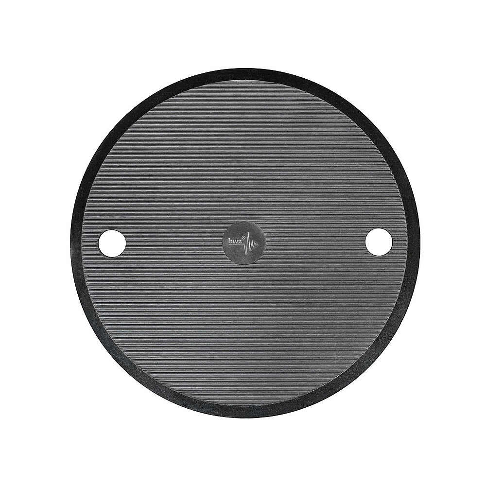 bottom side of a round machine foot made of black composite material with 120 mm diameter and in-laid black elastomer made of nitrile rubber NBR for non-slip protection, with fine horizontal grooved lines and two boreholes at the sides, as well as a centered logo of the company 'bwz Schwingungstechnik', isolated on white background