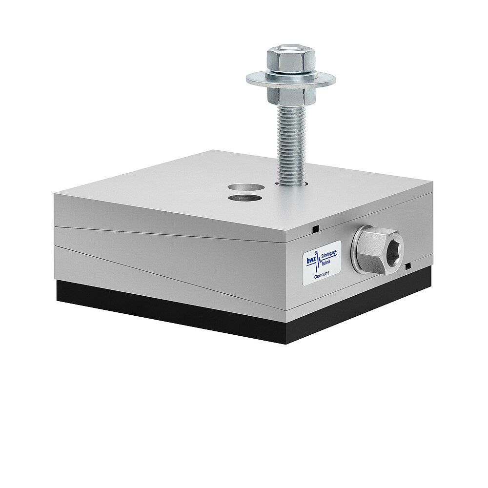 a square, height-adjustable machine mount made of precision-milled metal, adjusted in middle position, consisting of top, middle and bottom part lacquered in silver colour, with the wedge-shaped middle part featuring a protruding centered hexagonal screw for height adjustment, two holes for fastening screws in the top part, a fastening screw fastened in the bottom part and a medium-thick black elastomer with smooth surface for vibration damping at the bottom, isolated on white background