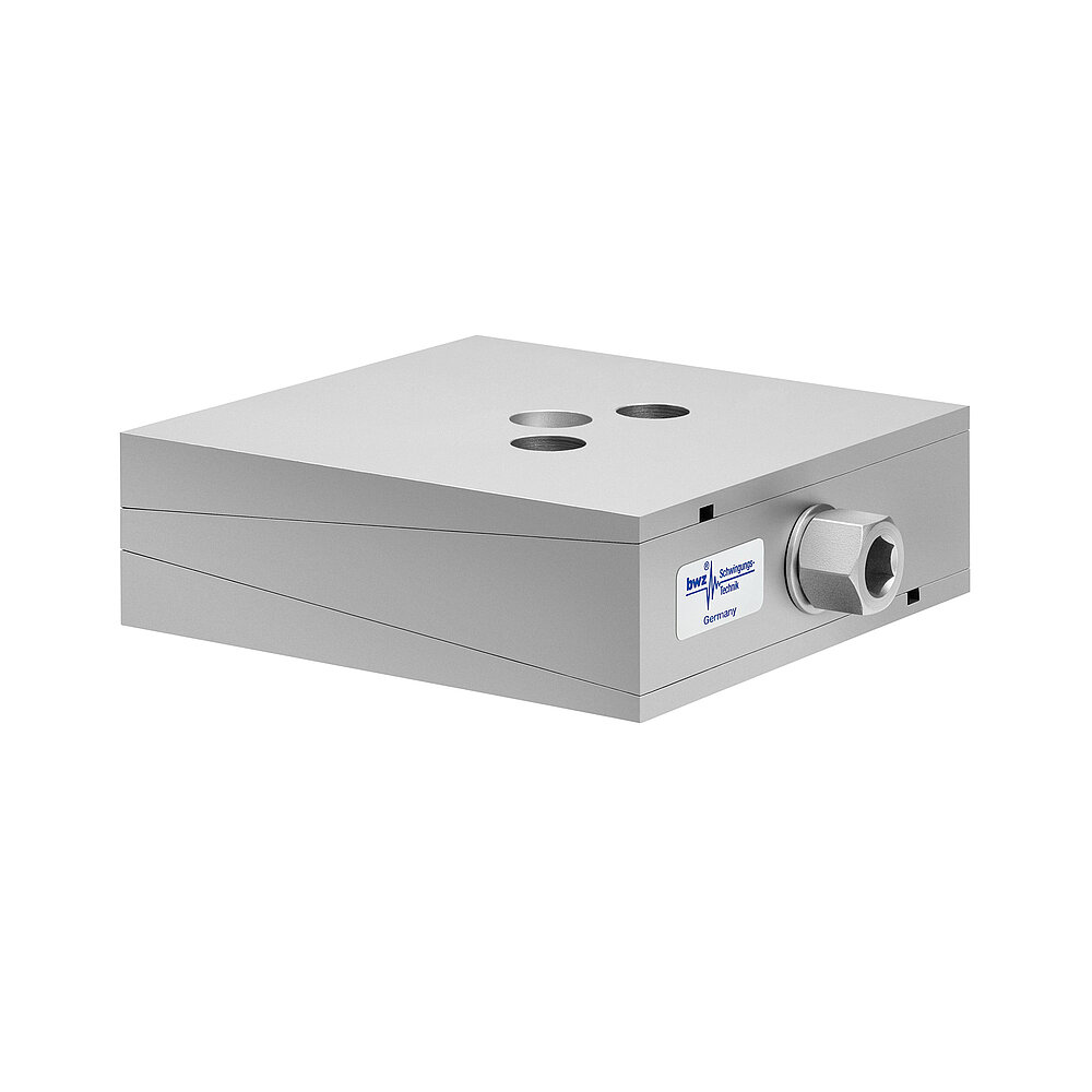 a square, height-adjustable machine mount made of precision-milled metal, adjusted in middle position, consisting of top, middle and bottom part lacquered in silver colour, with the wedge-shaped middle part featuring a protruding centered hexagonal screw for height adjustment and two holes for fastening screws in the top part, isolated on white background